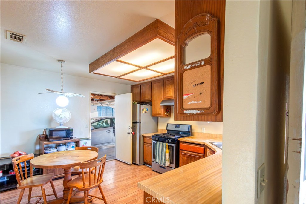 3579 Paine Drive Riverside, CA 92503 - Photo 12 of 31 a kitchen with stainless steel appliances kitchen island granite countertop a sink and a refrigerator