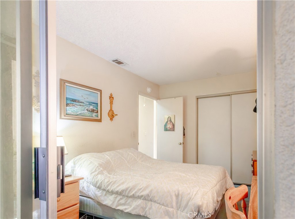 3579 Paine Drive Riverside, CA 92503 - Photo 20 of 31 a bedroom with a bed and hallway