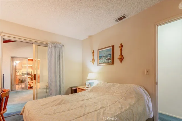 a bedroom with a bed and a large mirror