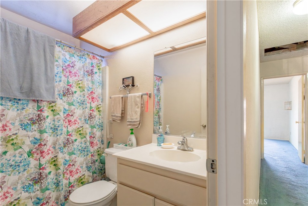 3579 Paine Drive Riverside, CA 92503 - Photo 23 of 31 a bathroom with a sink mirror vanity and toilet