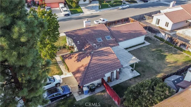 an aerial view of a house with garden space and street view