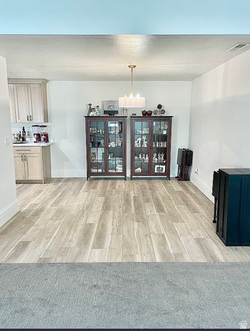 838 East Mountain Road North Ogden, UT 84414 - Photo 34 of 37 Open concept living space featuring wood-finish flooring, white baseboards, and a modern drum pendant light fixture