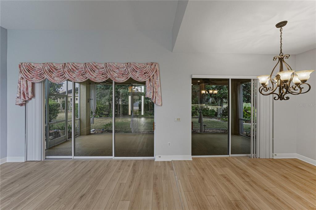 8725 Mississippi Run Spring Hill, FL 34613 - Photo 16 of 72 a view of a room with wooden floor and flat screen tv