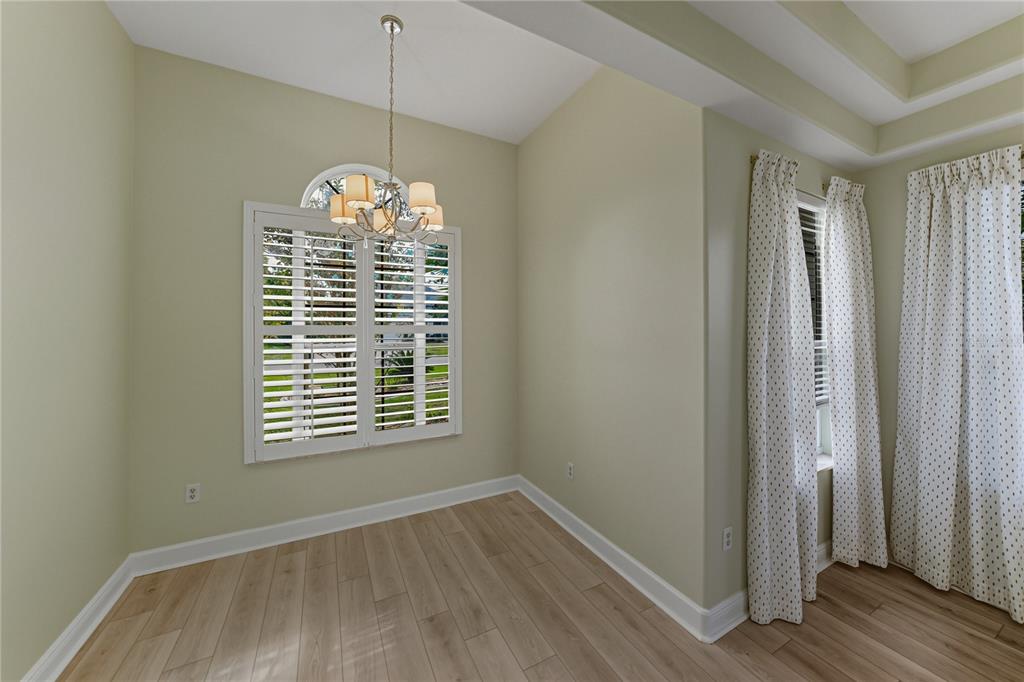 8725 Mississippi Run Spring Hill, FL 34613 - Photo 32 of 72 a view of an empty room with wooden floor and a window