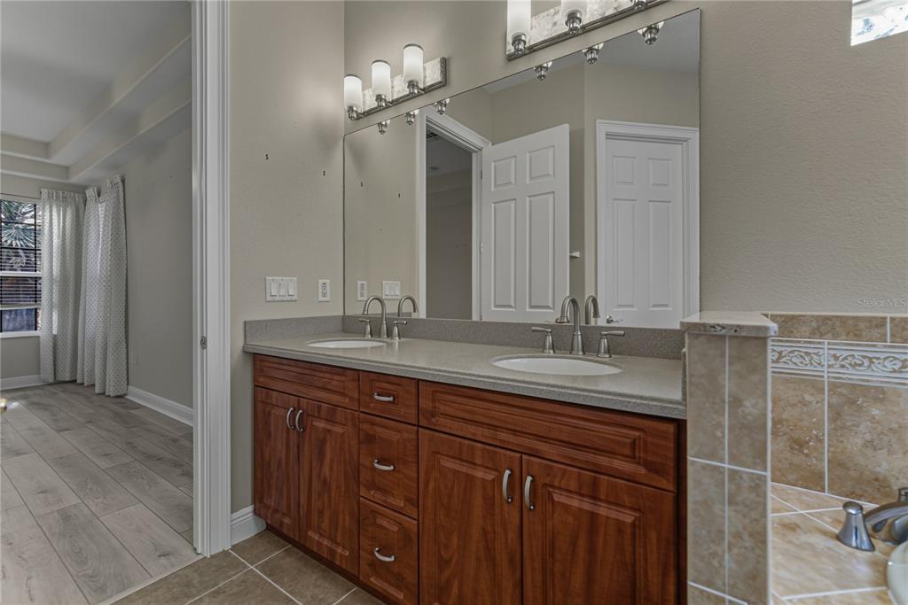 8725 Mississippi Run Spring Hill, FL 34613 - Photo 38 of 72 a bathroom with a granite countertop sink and a mirror