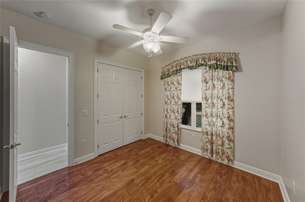 8725 Mississippi Run Spring Hill, FL 34613 - Photo 44 of 72 wooden floor in an empty room with a mirror