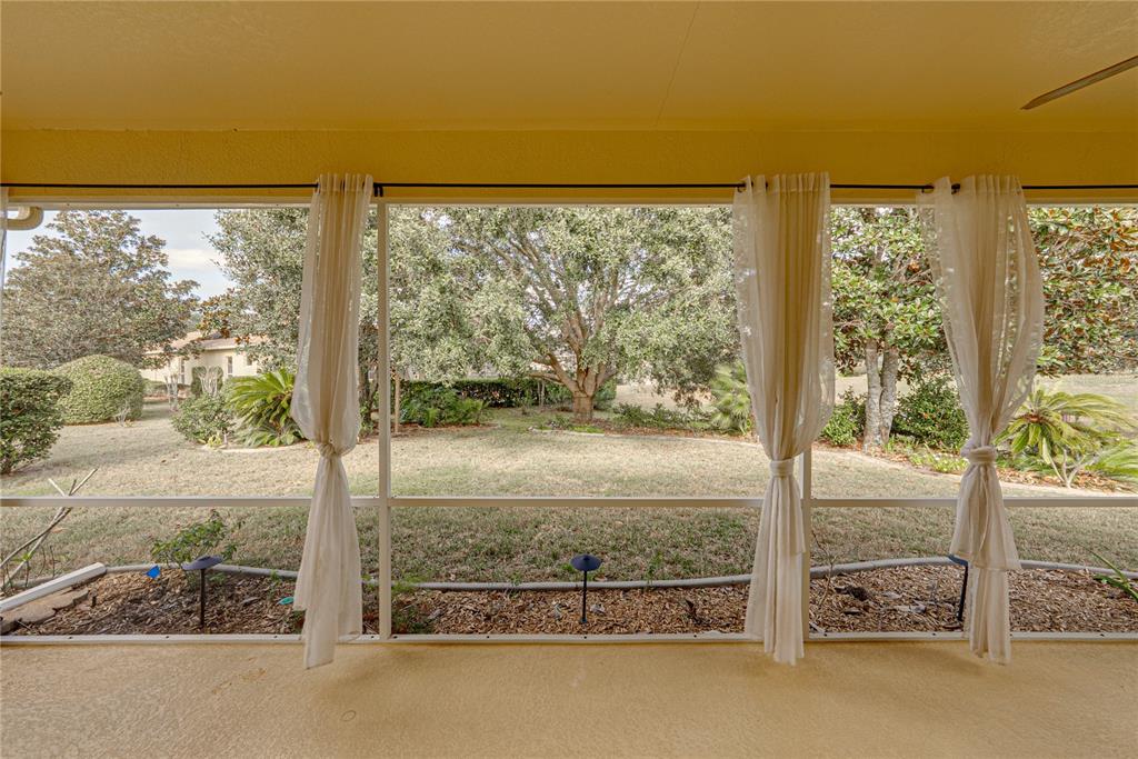 8725 Mississippi Run Spring Hill, FL 34613 - Photo 46 of 72 a view of a glass door with a yard