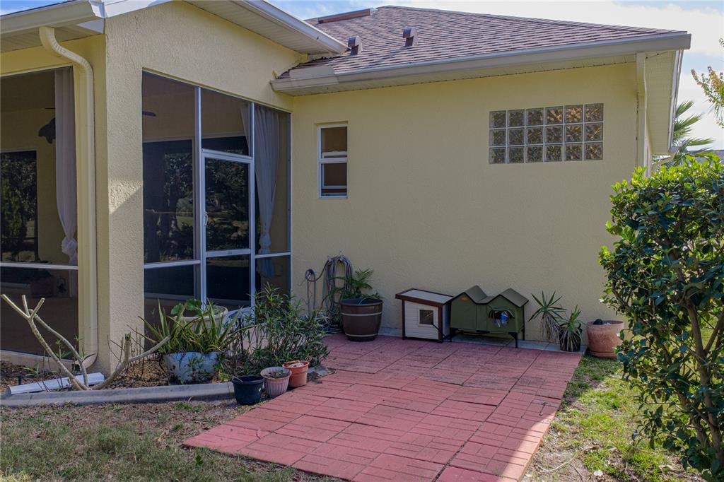 8725 Mississippi Run Spring Hill, FL 34613 - Photo 53 of 72 a view of a patio with table and chairs potted plants