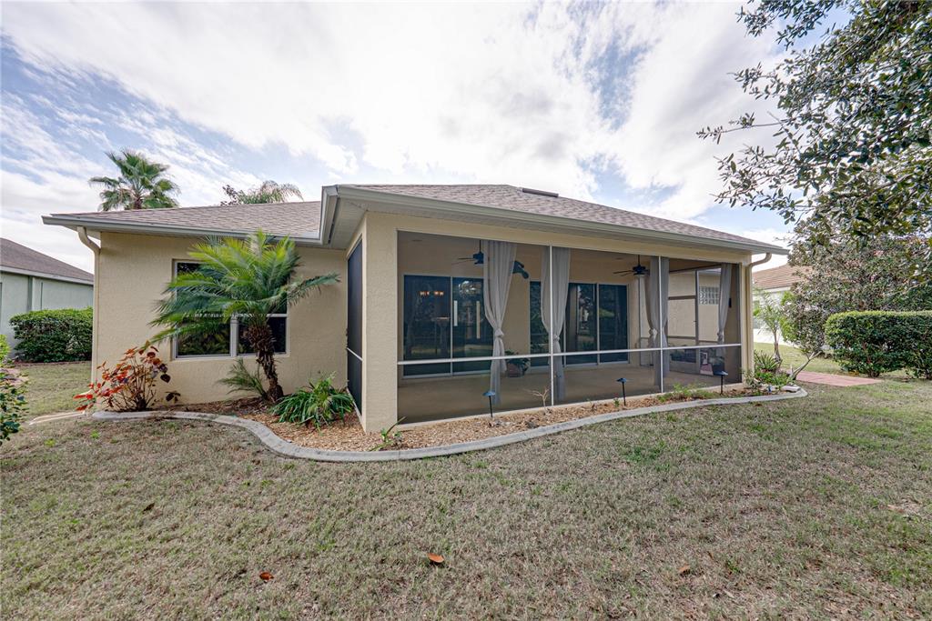 8725 Mississippi Run Spring Hill, FL 34613 - Photo 54 of 72 a view of a house with a yard and potted plants