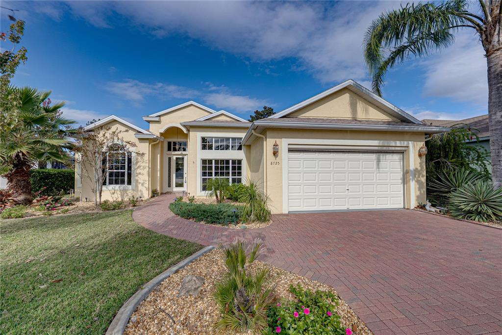 8725 Mississippi Run Spring Hill, FL 34613 - Photo 7 of 72 a front view of a house with a yard and garage