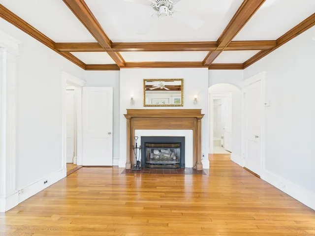a living room with a fireplace and a wooden floor