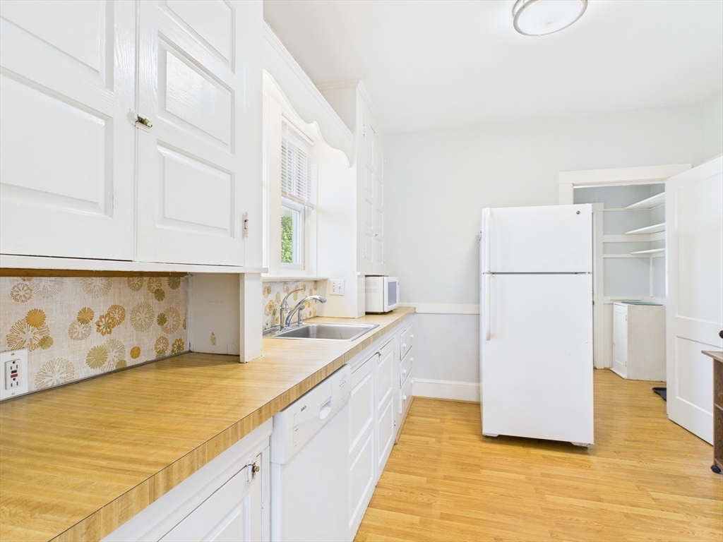 1120 Centre Street, Unit 1 Newton, MA 02459 - Photo 18 of 34 a kitchen with a sink and a refrigerator