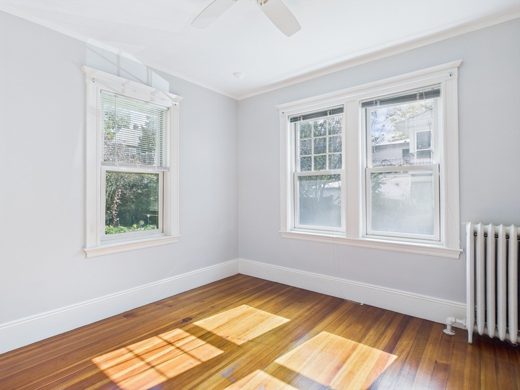 1120 Centre Street, Unit 1 Newton, MA 02459 - Photo 33 of 34 a view of an empty room with wooden floor and a window
