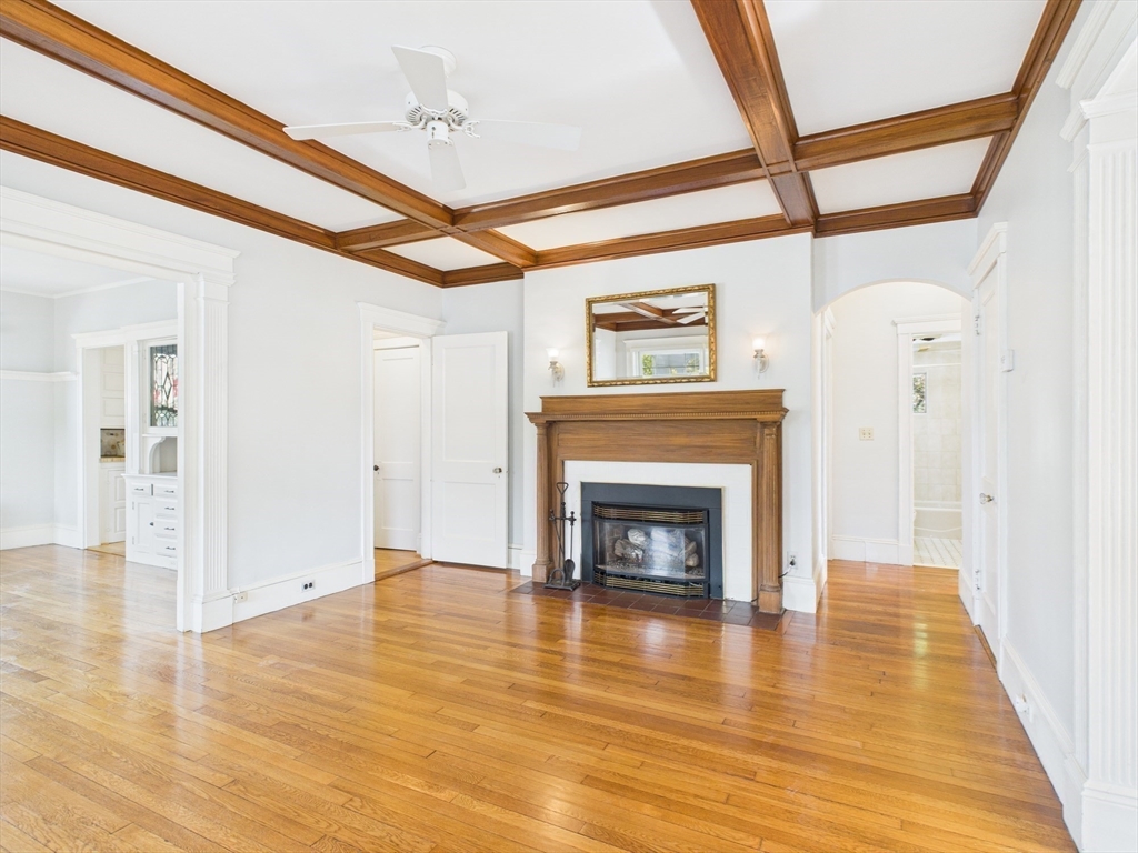 1120 Centre Street, Unit 1 Newton, MA 02459 - Photo 8 of 34 a view of an empty room with wooden floor fire place