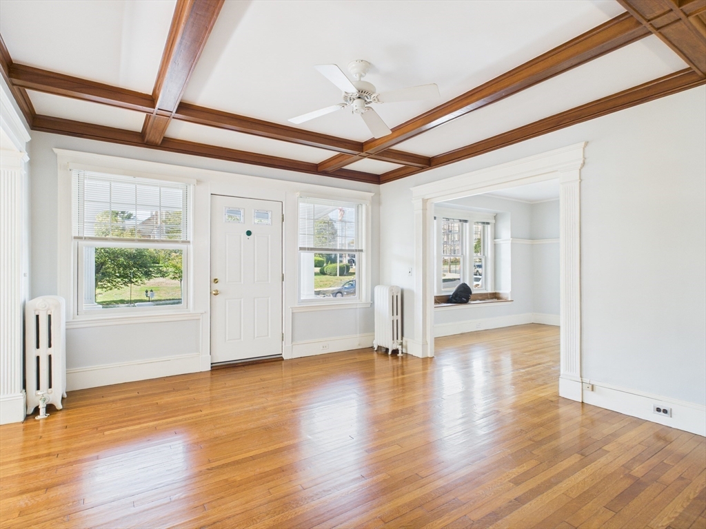 1120 Centre Street, Unit 1 Newton, MA 02459 - Photo 10 of 34 a view of an empty room with wooden floor and a window