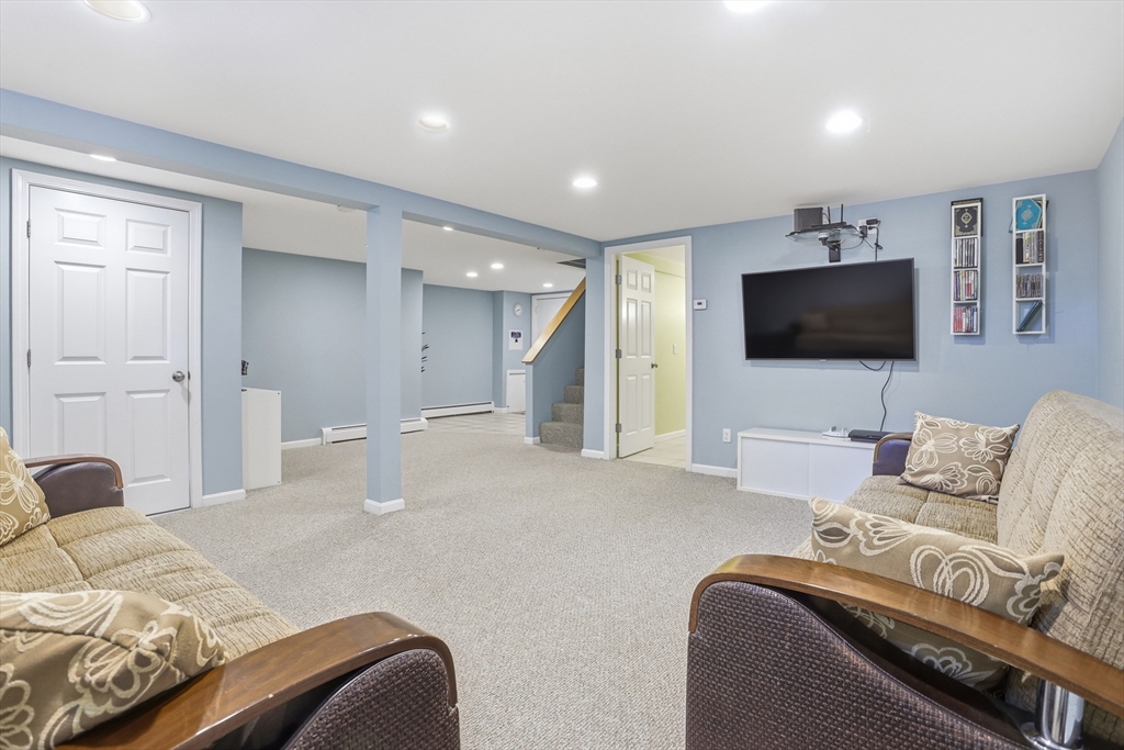 115 Collincote Street Stoneham, MA 02180 - Photo 17 of 25 a living room with furniture and a flat screen tv
