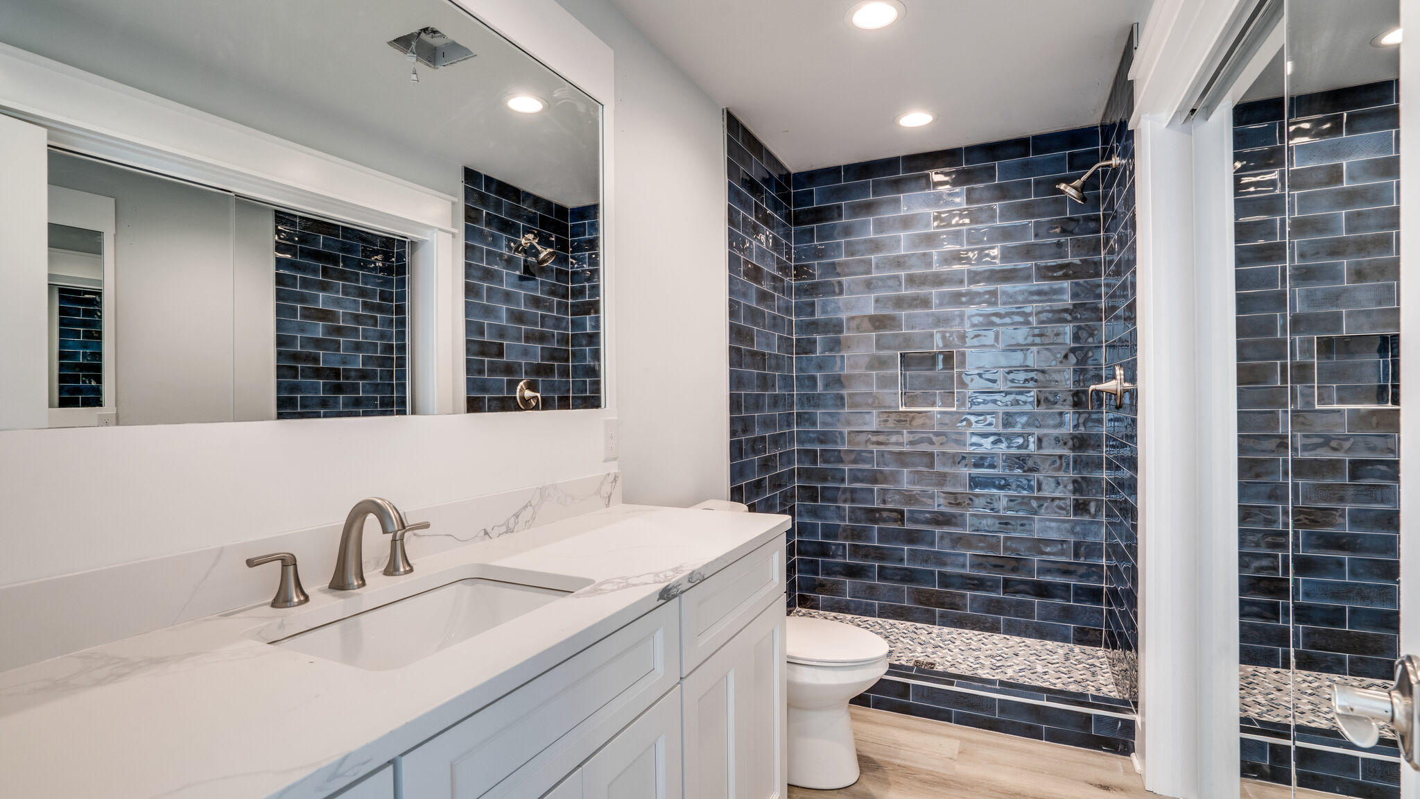 393 Redbud Ln Inlet Beach Inlet Beach, FL 32461 - Photo 25 of 46 a bathroom with a sink a toilet a shower and a mirror