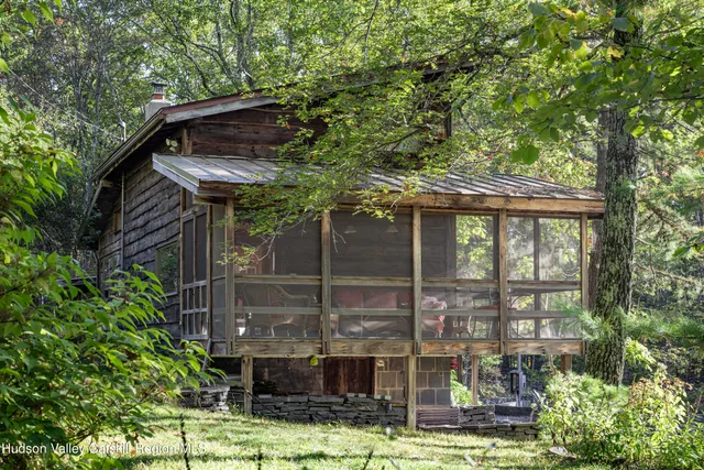 a backyard of a house with yard and outdoor seating