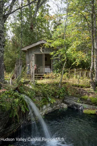 a view of backyard of house with outdoor seating and green space