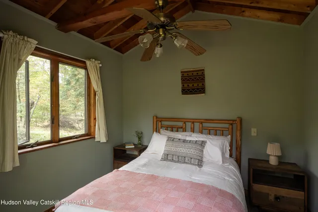 a backyard of a house with barbeque oven and trees