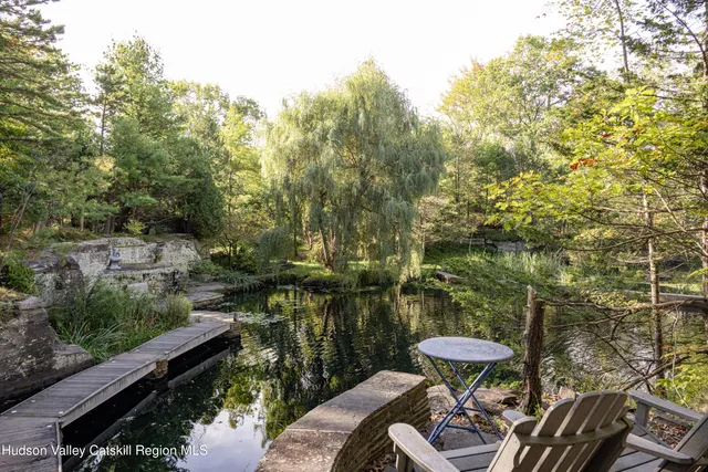 a view of house with large trees in front
