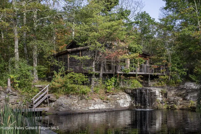 an aerial view of a residential houses with yard