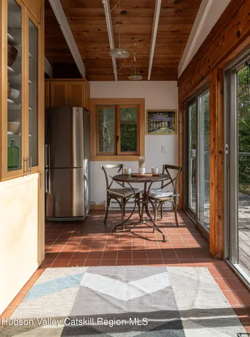 a view of a patio with table and chairs next to a window