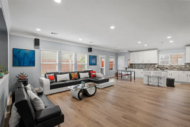 a living room with furniture and kitchen view