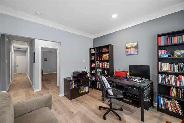 a view of a livingroom with workspace and a bookshelf