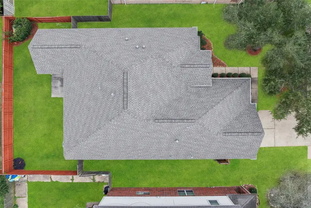an aerial view of a house with a yard