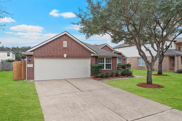 a front view of house with yard and green space