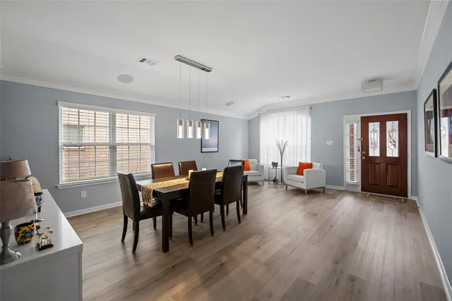 a view of a dining room with furniture and wooden floor