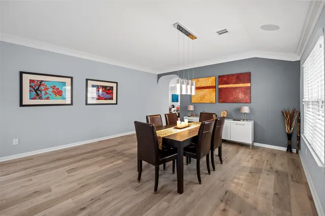 a view of a dining room with furniture and a window