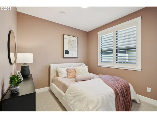 a bedroom with a large bed and a window