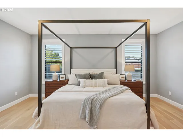 a bedroom with a bed and a large window