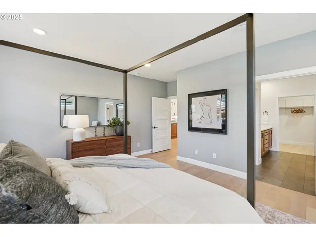 a bedroom with a large bed and a chandelier