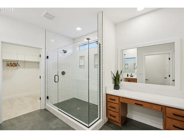 a bathroom with a shower sink and mirror