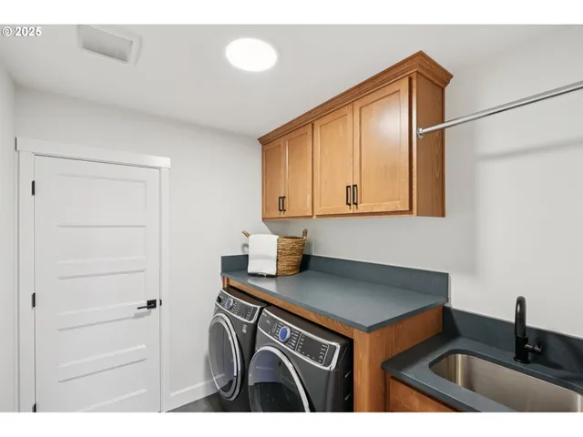 a kitchen with a sink cabinets and a stove