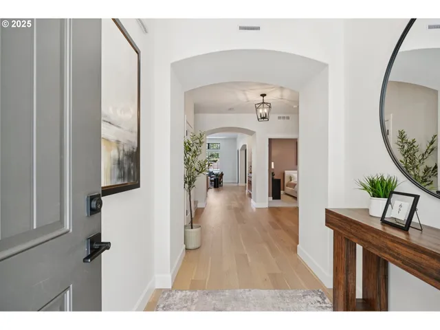 a living room with furniture and a mirror