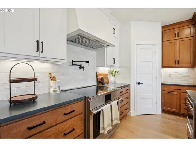 a kitchen with stainless steel appliances granite countertop a refrigerator and a stove