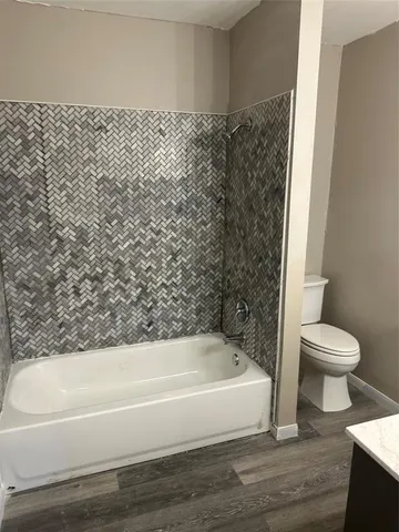 a bathroom with a bathtub and toilet