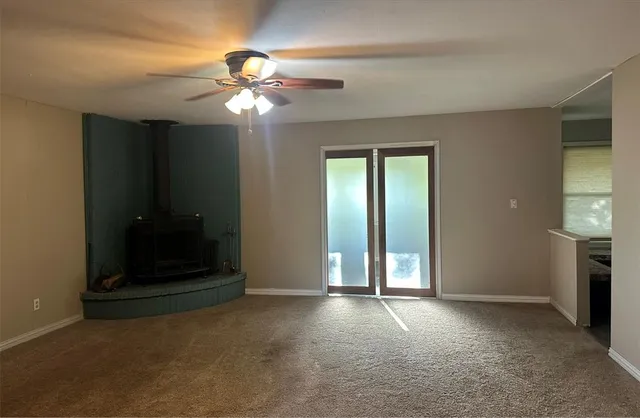 an empty room with closet and a chandelier fan