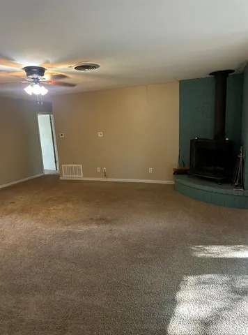 a view of an empty room with a fireplace
