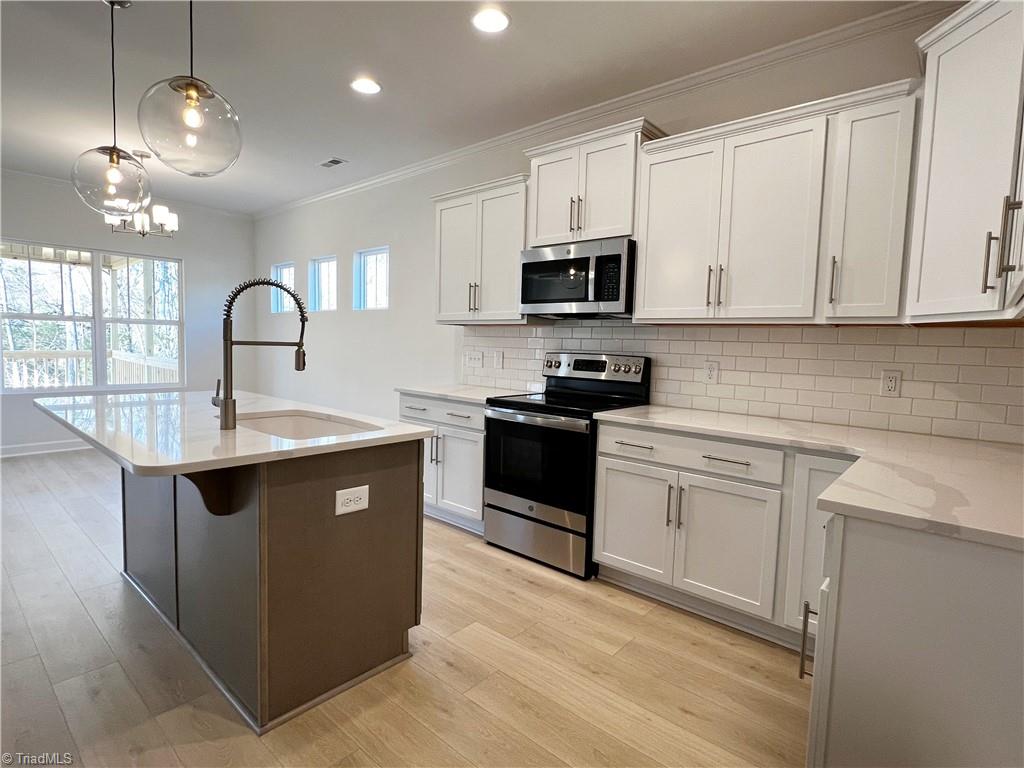 7707 Sedgewick Ridge Road Lewisville, NC 27023 - Photo 8 of 35 Kitchen w/ SS Appliances & Contrasting Island