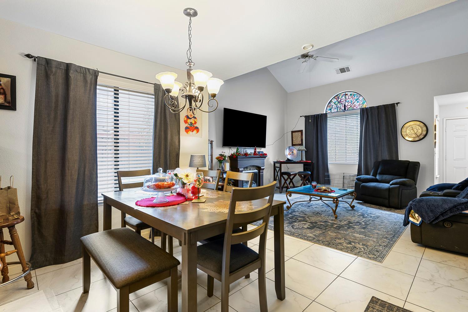 1592 North Ferger Avenue Fresno, CA 93728 - Photo 12 of 30 a view of a dining room with furniture window and wooden floor