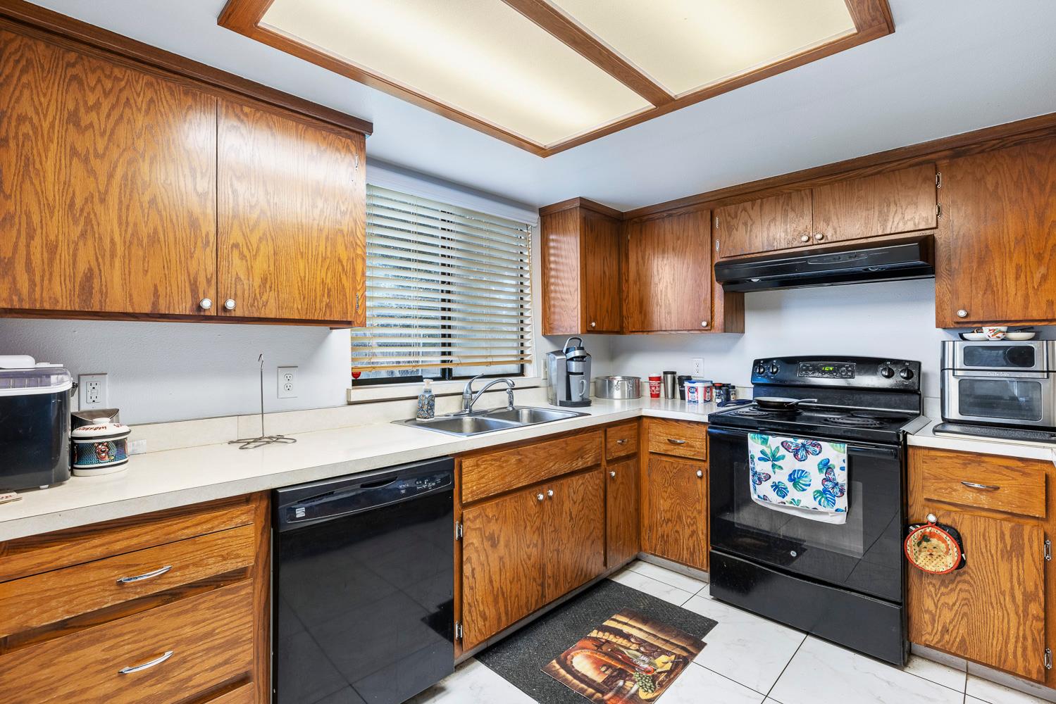 1592 North Ferger Avenue Fresno, CA 93728 - Photo 13 of 30 a kitchen with stainless steel appliances granite countertop a sink stove and cabinets