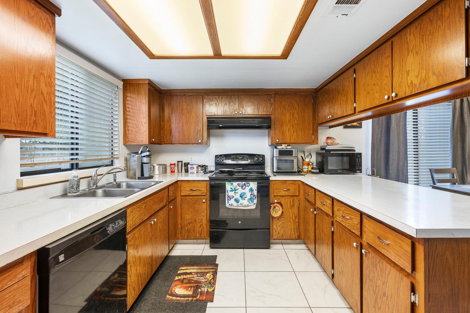 1592 North Ferger Avenue Fresno, CA 93728 - Photo 14 of 30 a kitchen with stainless steel appliances granite countertop a sink stove and cabinets