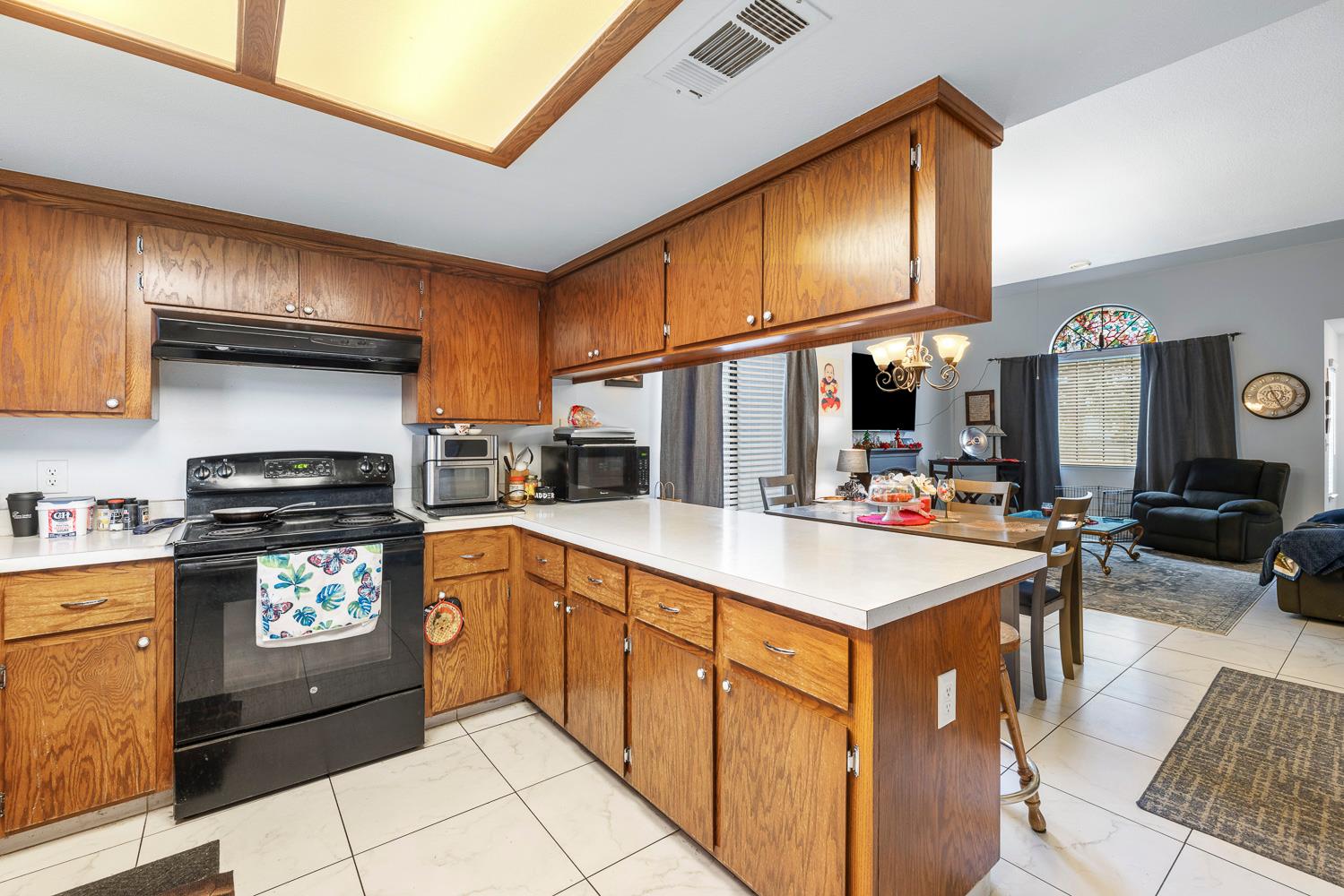 1592 North Ferger Avenue Fresno, CA 93728 - Photo 15 of 30 a kitchen with stainless steel appliances granite countertop a sink stove and cabinets
