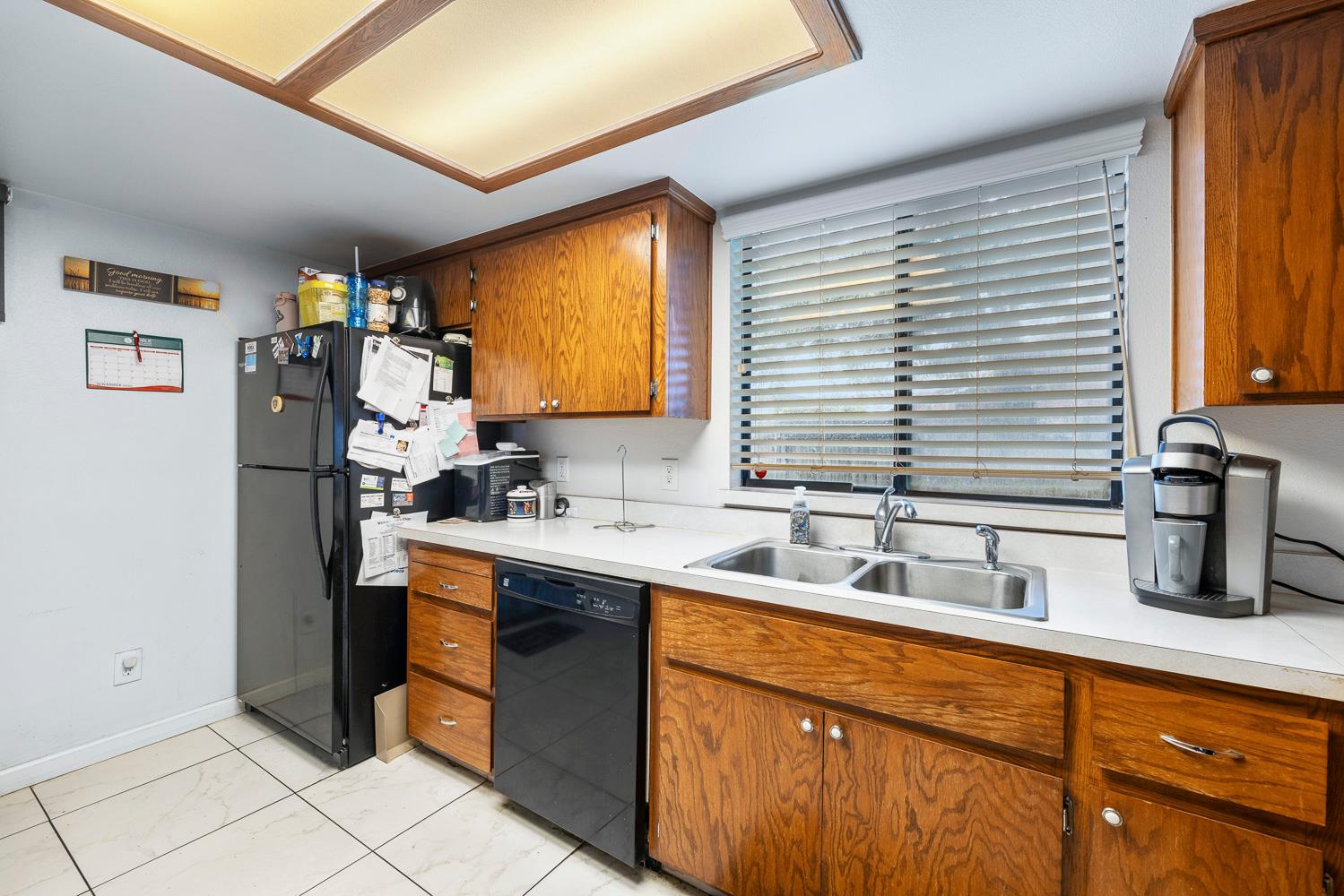 1592 North Ferger Avenue Fresno, CA 93728 - Photo 16 of 30 a kitchen with stainless steel appliances granite countertop a sink and a refrigerator