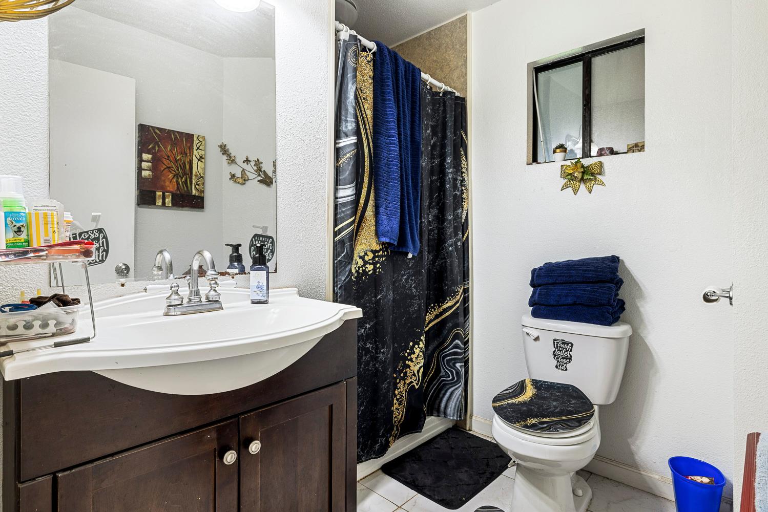 1592 North Ferger Avenue Fresno, CA 93728 - Photo 18 of 30 a bathroom with a sink a toilet and mirror